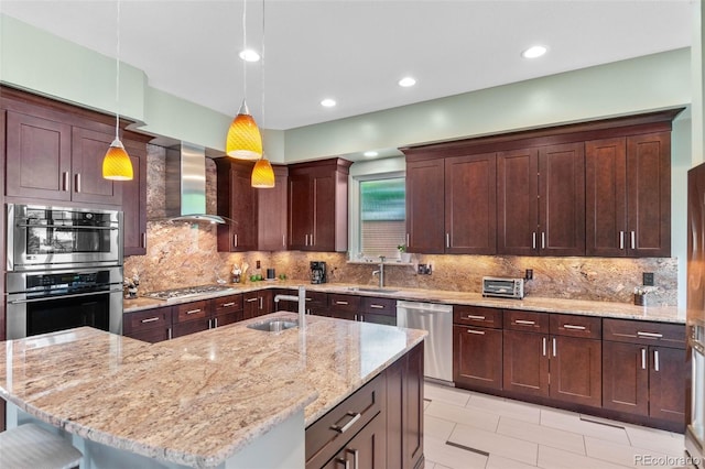 1344 S Saint Paul St, Denver, CO 80210 - kitchen featuring stainless steel appliances, wall chimney exhaust hood, light stone counters, hanging light fixtures, and recessed lighting
