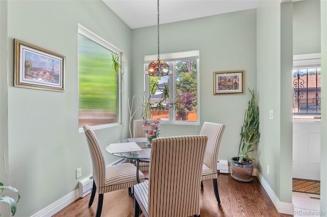 1344 S Saint Paul St, Denver, CO 80210 - dining area featuring healthy amount of natural light, wood finished floors, and a baseboard heating unit