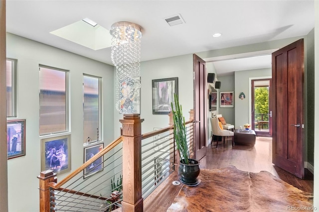 1344 S Saint Paul St, Denver, CO 80210 - hallway with an upstairs landing, wood finished floors, a chandelier, a skylight, and recessed lighting