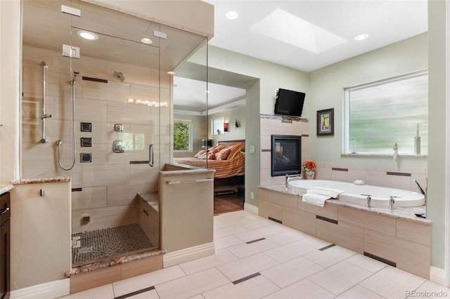 1344 S Saint Paul St, Denver, CO 80210 - ensuite bathroom featuring a skylight, a garden tub, a shower stall, a glass covered fireplace, and recessed lighting