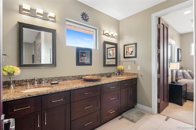 1344 S Saint Paul St, Denver, CO 80210 - ensuite bathroom featuring double vanity, healthy amount of natural light, and tile patterned floors