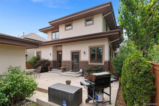 1344 S Saint Paul St, Denver, CO 80210 - rear view of property featuring stucco siding and a patio