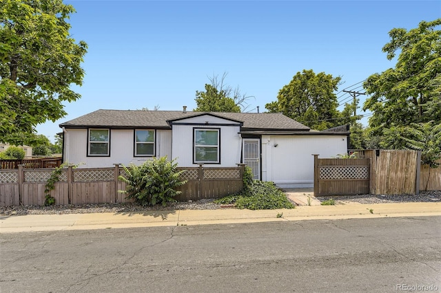 1187 Syracuse St, Denver, CO 80220 - view of front of home featuring a fenced front yard and roof with shingles