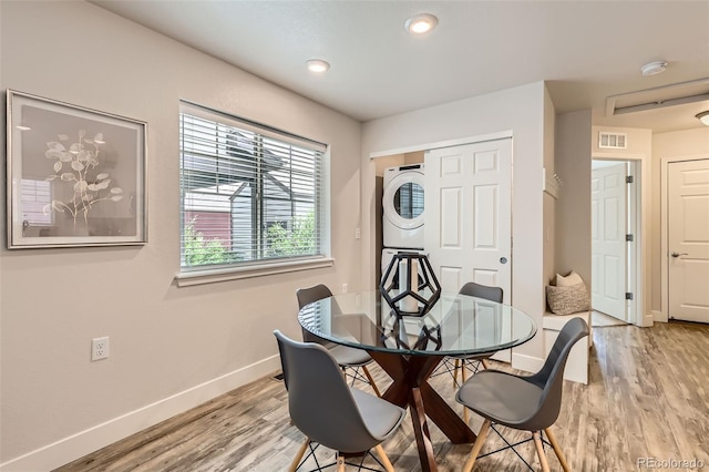 65 Avocet Ct, Longmont, CO 80501 - dining space featuring stacked washer and clothes dryer, baseboards, light wood-style flooring, and recessed lighting