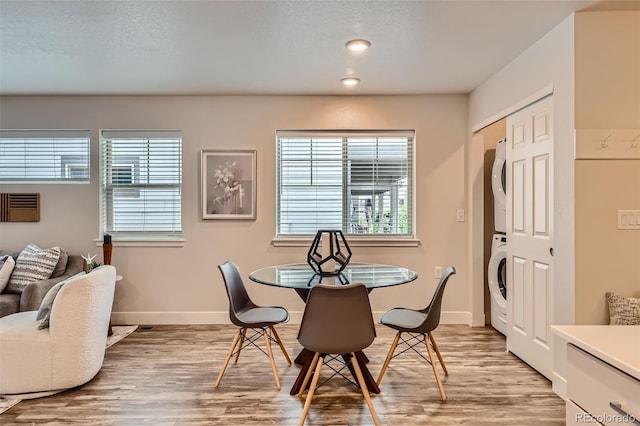 65 Avocet Ct, Longmont, CO 80501 - dining space with stacked washer / drying machine, light wood-style floors, plenty of natural light, and baseboards