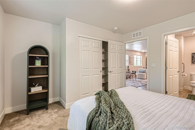 65 Avocet Ct, Longmont, CO 80501 - bedroom featuring light carpet, baseboards, a closet, and ensuite bathroom