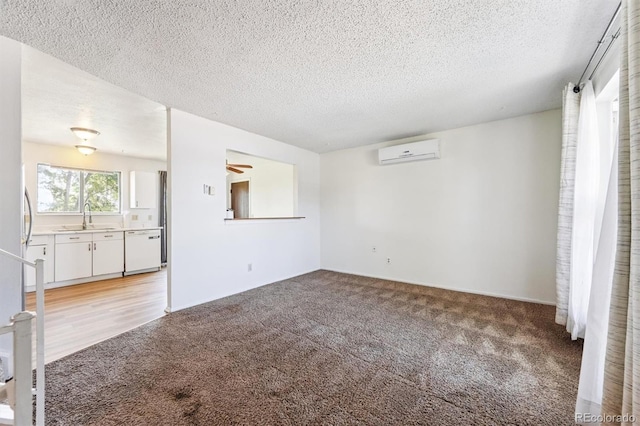 5372 E 108th Pl, Thornton, CO 80233 - unfurnished living room featuring a wall mounted AC, light colored carpet, and a textured ceiling