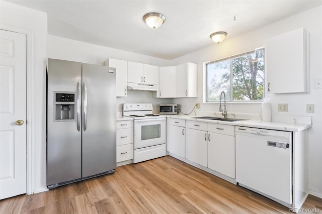 5372 E 108th Pl, Thornton, CO 80233 - kitchen with white appliances, under cabinet range hood, light countertops, white cabinetry, and light wood-style floors