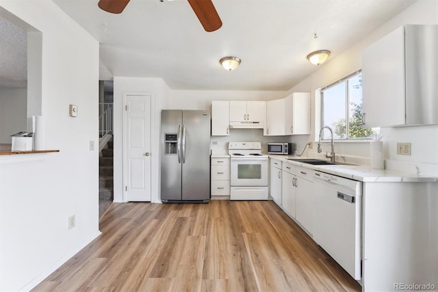 5372 E 108th Pl, Thornton, CO 80233 - kitchen with stainless steel appliances, under cabinet range hood, light countertops, ceiling fan, and light wood-type flooring