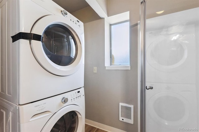 5372 E 108th Pl, Thornton, CO 80233 - washroom featuring estacked washer and dryer and baseboards