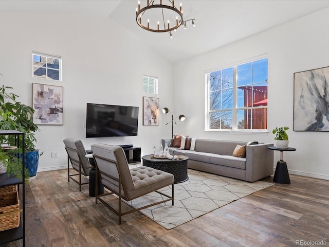 living room with visible vents, baseboards, a chandelier, vaulted ceiling, and wood finished floors