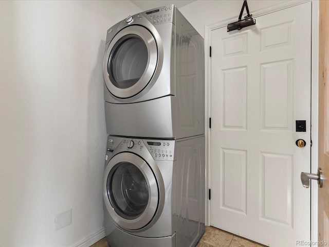 clothes washing area with laundry area and stacked washer and dryer