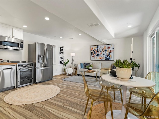 dining space with visible vents, recessed lighting, light wood-type flooring, and baseboards