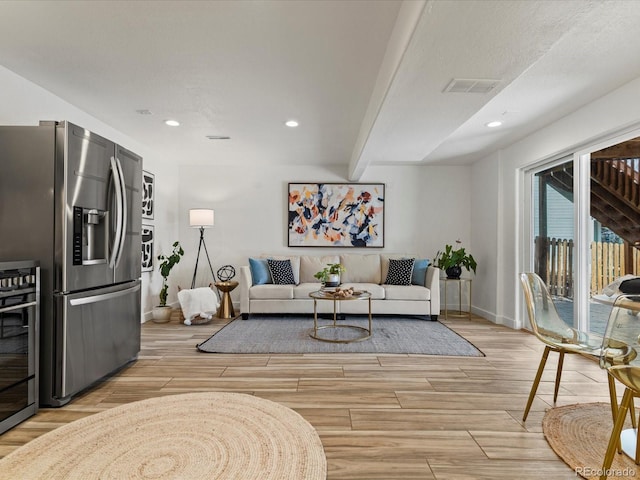 living area featuring visible vents, baseboards, wood finish floors, wine cooler, and recessed lighting