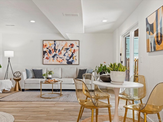 living area with recessed lighting, visible vents, and light wood finished floors