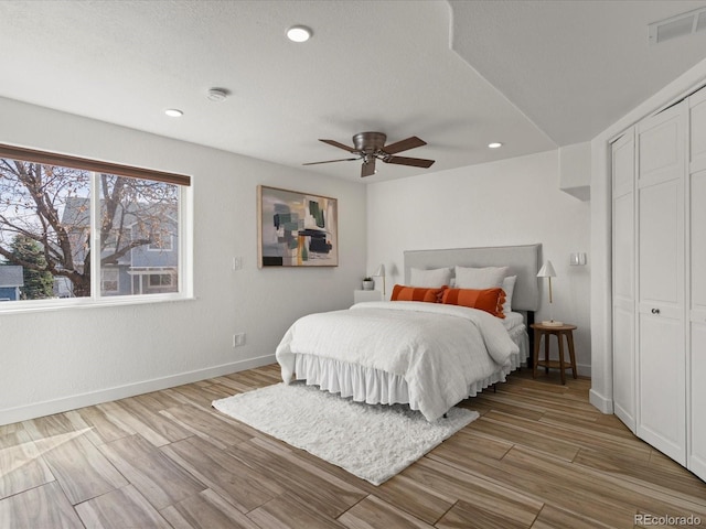 bedroom featuring visible vents, baseboards, and wood finished floors