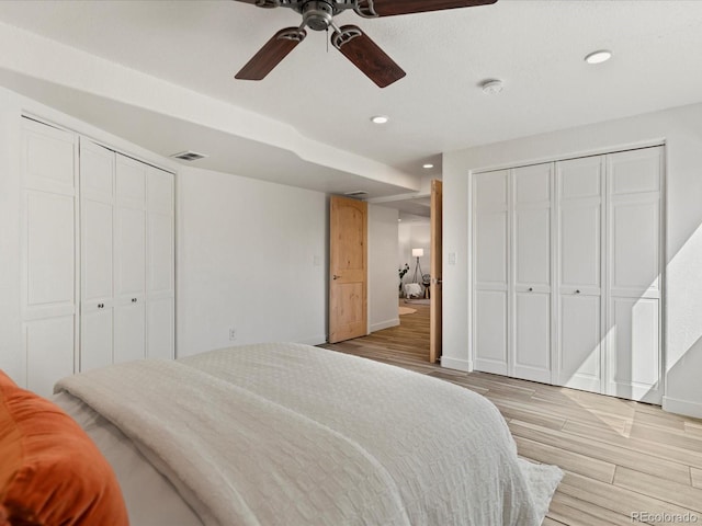 bedroom featuring a ceiling fan, visible vents, light wood finished floors, baseboards, and recessed lighting