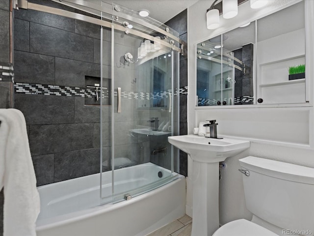 full bathroom featuring combined bath / shower with glass door and toilet