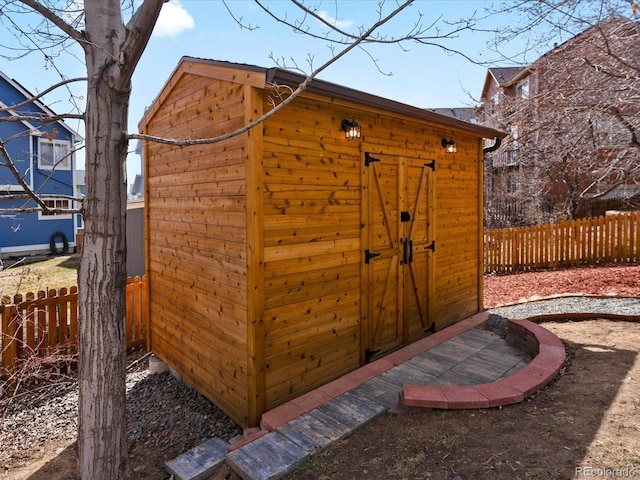 view of shed with fence