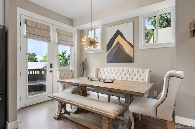2805 S Sherman St, Englewood, CO 80113 - dining space featuring a chandelier, plenty of natural light, wood finished floors, and french doors