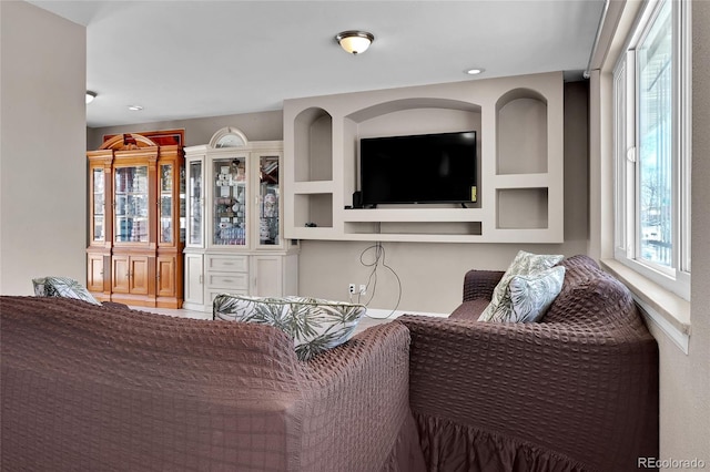 living room featuring built in shelves