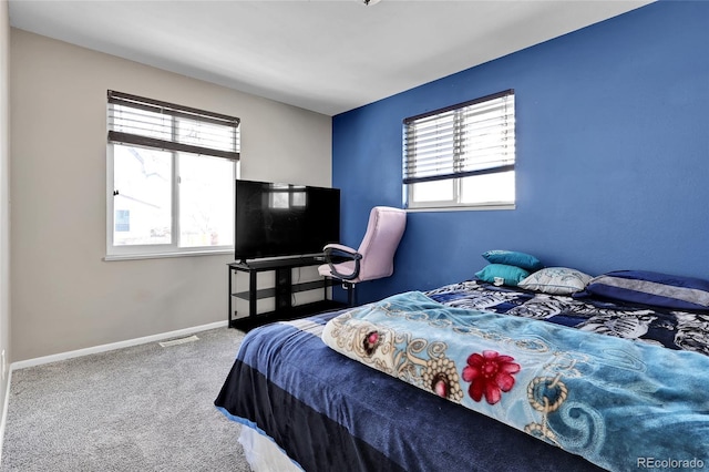 bedroom with carpet flooring and multiple windows