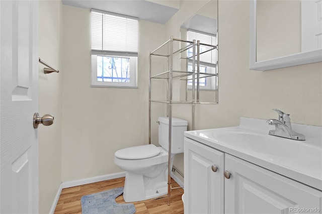 bathroom featuring hardwood / wood-style floors, vanity, and toilet