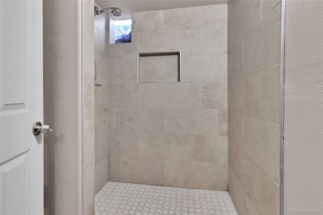 bathroom featuring tiled shower