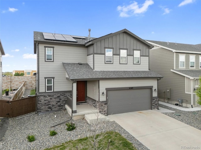 16369 Alberta Dr, Parker, CO 80134 - view of front of property featuring a garage, solar panels, board and batten siding, fence, and roof with shingles