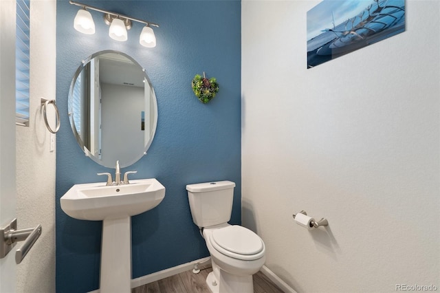 16369 Alberta Dr, Parker, CO 80134 - bathroom featuring wood finished floors, toilet, baseboards, and a sink