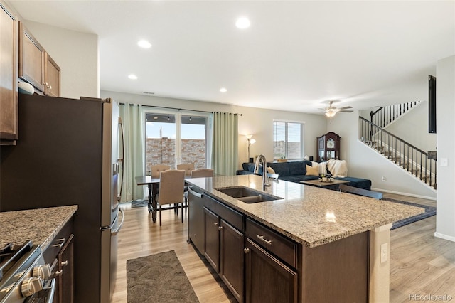16369 Alberta Dr, Parker, CO 80134 - kitchen featuring a sink, appliances with stainless steel finishes, light wood finished floors, open floor plan, and recessed lighting
