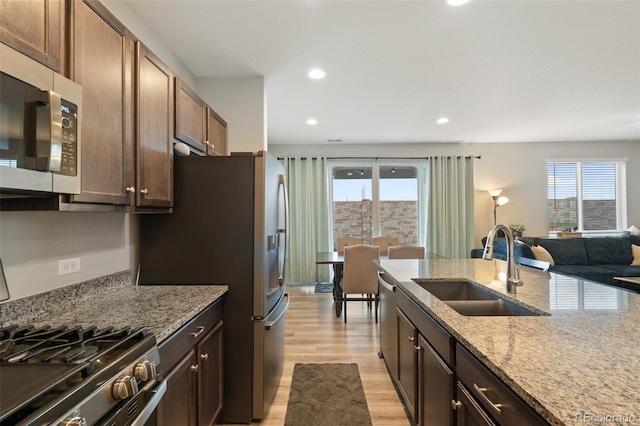 16369 Alberta Dr, Parker, CO 80134 - kitchen featuring stainless steel appliances, a sink, healthy amount of natural light, light wood-type flooring, and recessed lighting
