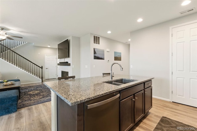 16369 Alberta Dr, Parker, CO 80134 - kitchen featuring a sink, dishwasher, dark brown cabinets, light wood-style floors, and ceiling fan