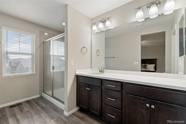 16369 Alberta Dr, Parker, CO 80134 - full bathroom featuring a shower stall, vanity, wood finished floors, ensuite bathroom, and baseboards