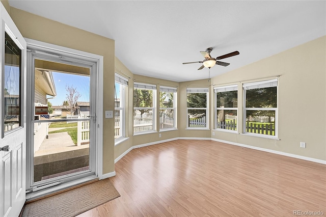 7870 Sunflower Grn Unit 151, Frederick, CO 80530 - unfurnished sunroom featuring lofted ceiling, baseboards, wood finished floors, and healthy amount of natural light
