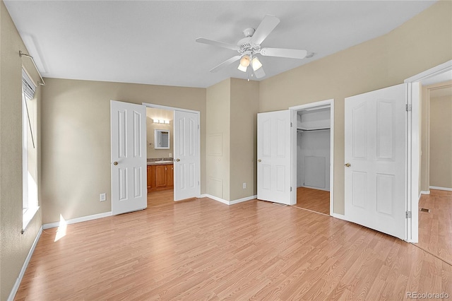 7870 Sunflower Grn Unit 151, Frederick, CO 80530 - unfurnished bedroom with light wood finished floors, baseboards, a walk in closet, connected bathroom, and a closet