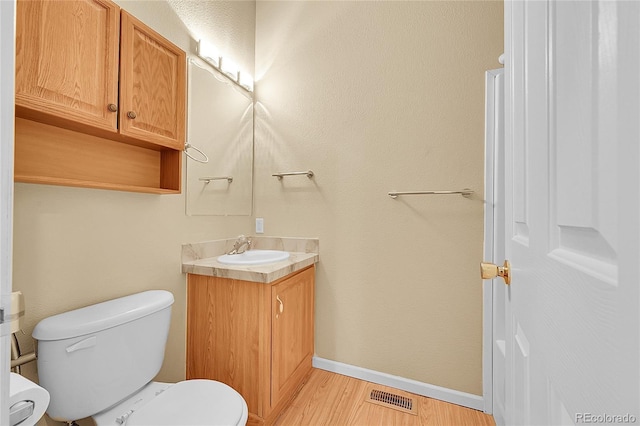 7870 Sunflower Grn Unit 151, Frederick, CO 80530 - half bath with toilet, wood finished floors, vanity, and baseboards
