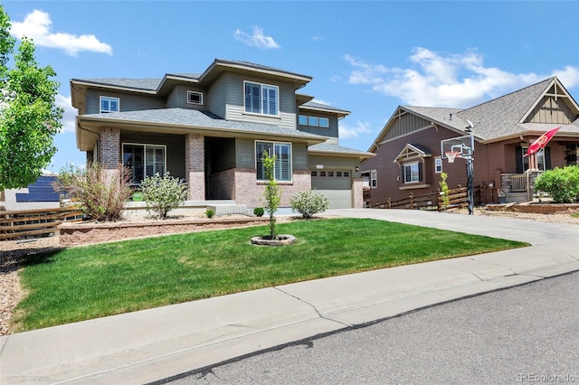 view of front of home featuring brick siding, a front yard, driveway, covered porch, and an attached garage