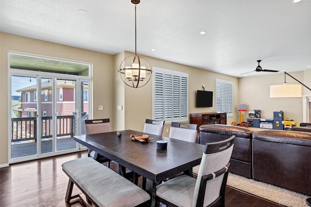 dining room featuring wood finished floors, a chandelier, ceiling fan, and recessed lighting