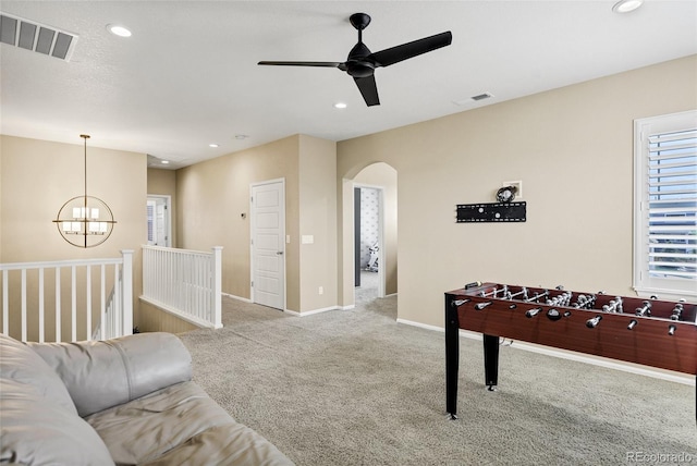 game room with arched walkways, carpet, a chandelier, a ceiling fan, and recessed lighting