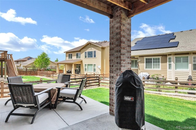 view of patio / terrace with a grill and a residential view