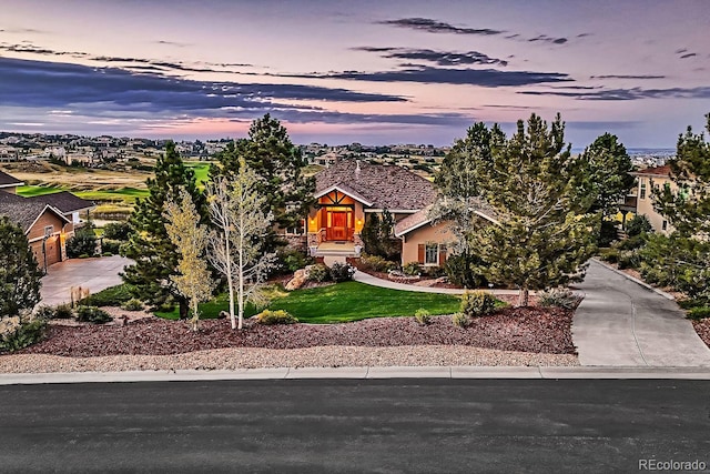 obstructed view of property with a front yard, a garage, and driveway