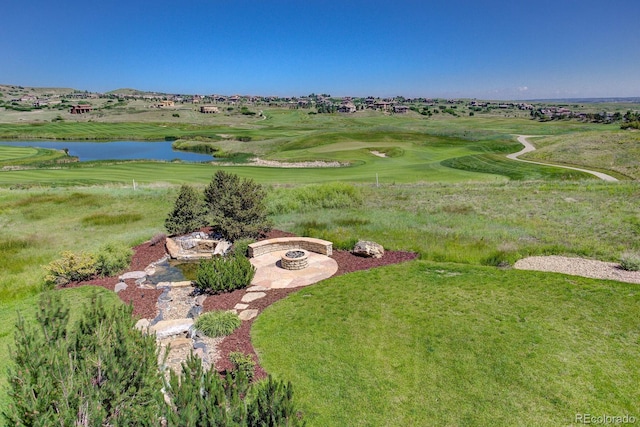 birds eye view of property featuring golf course view and a water view