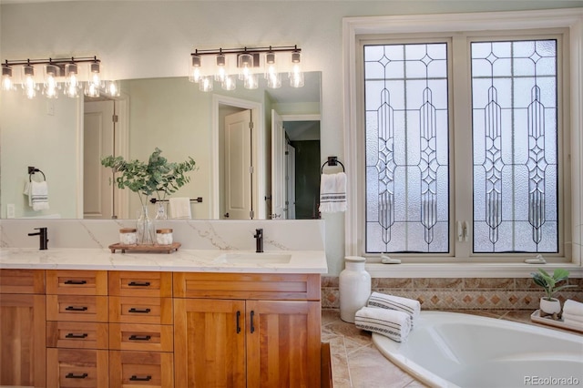 bathroom featuring double vanity, a washtub, and a sink