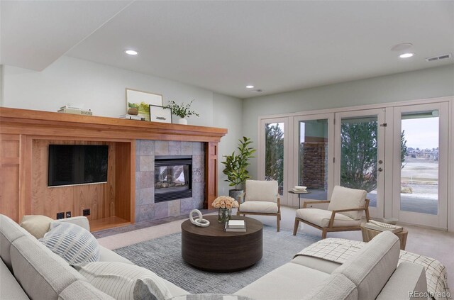 living area with recessed lighting, visible vents, and a tile fireplace