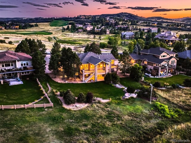 aerial view at dusk featuring a residential view