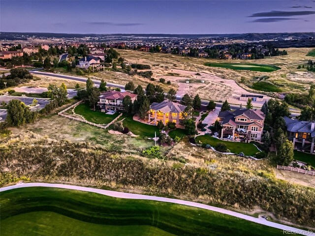 drone / aerial view with a residential view and golf course view