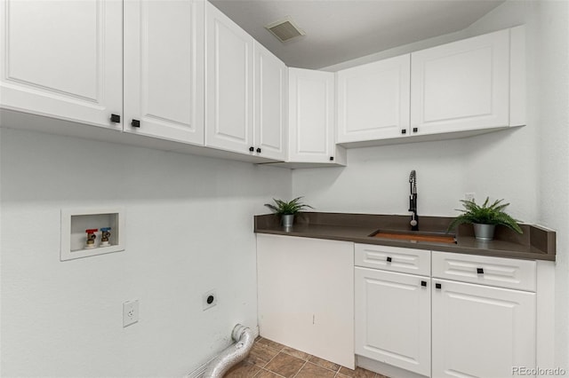 washroom with electric dryer hookup, cabinets, sink, and hookup for a washing machine