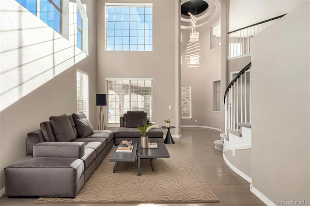 living room with hardwood / wood-style flooring and a towering ceiling