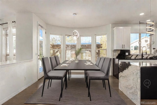 dining room with a notable chandelier, a healthy amount of sunlight, and sink